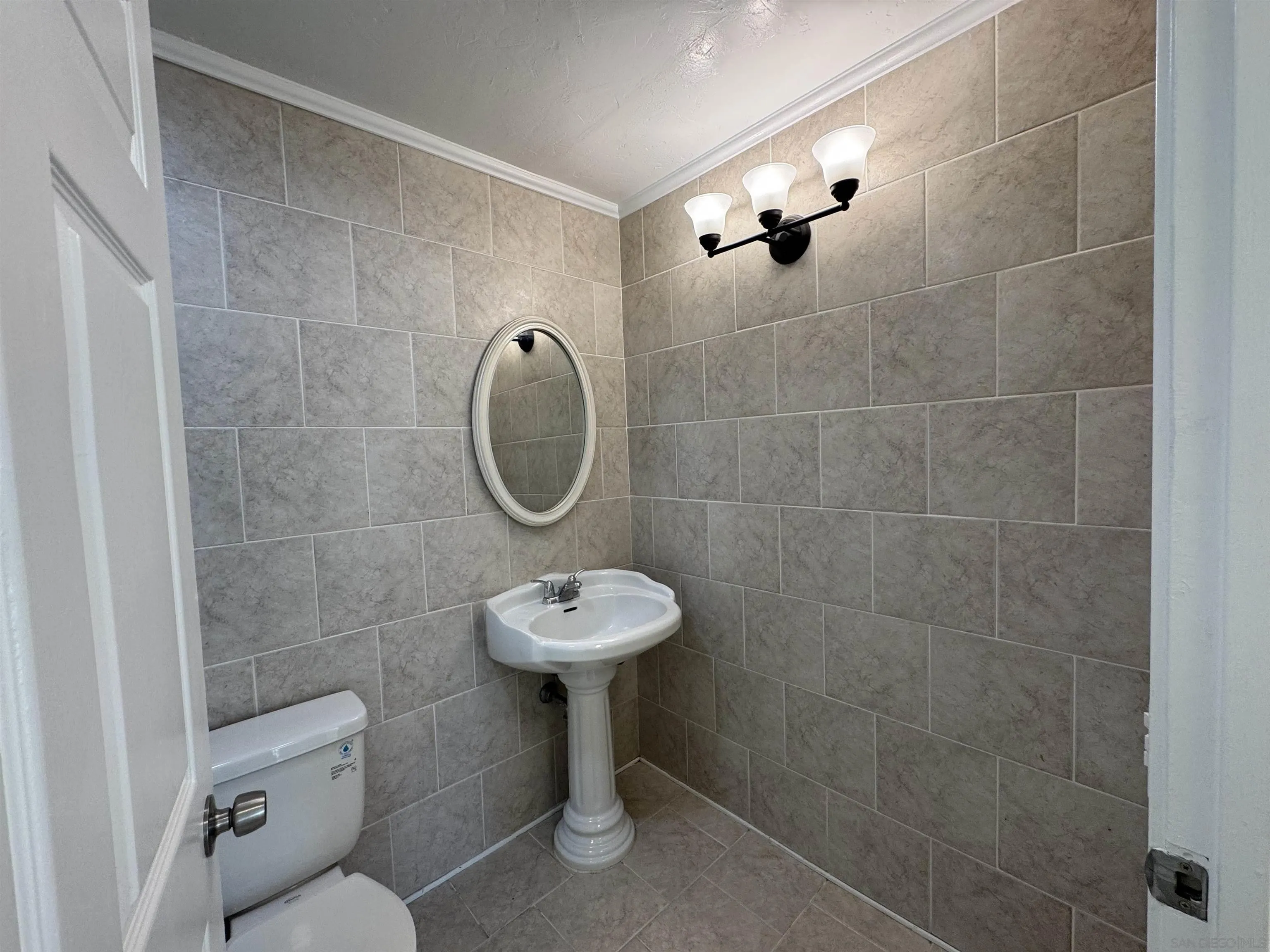 12923 Mapleview Street, Unit 8 Lakeside, CA 92040 - Photo 14 of 25 a bathroom with a toilet sink and mirror
