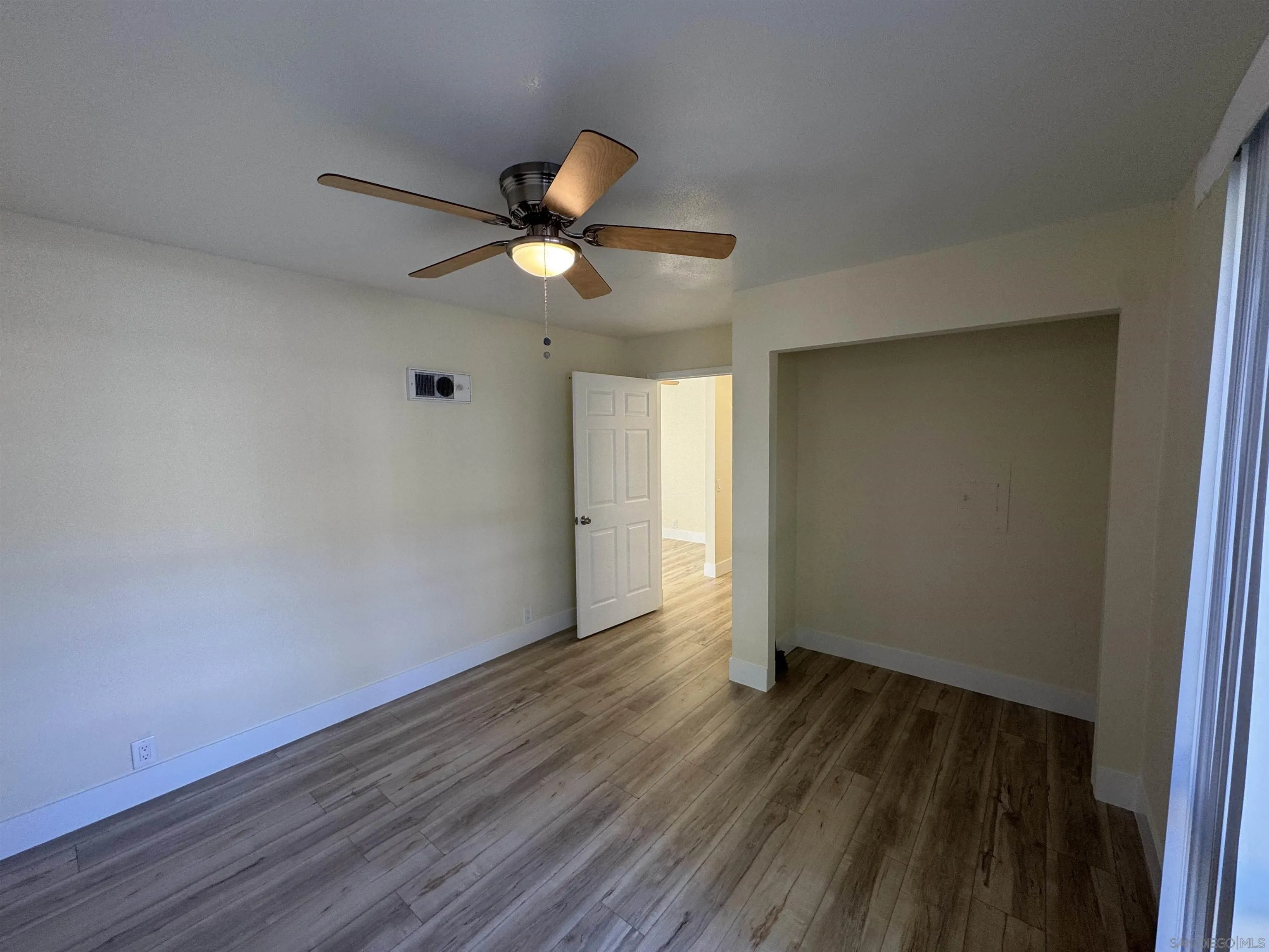 12923 Mapleview Street, Unit 8 Lakeside, CA 92040 - Photo 20 of 25 an empty room with wooden floor and a ceiling fan