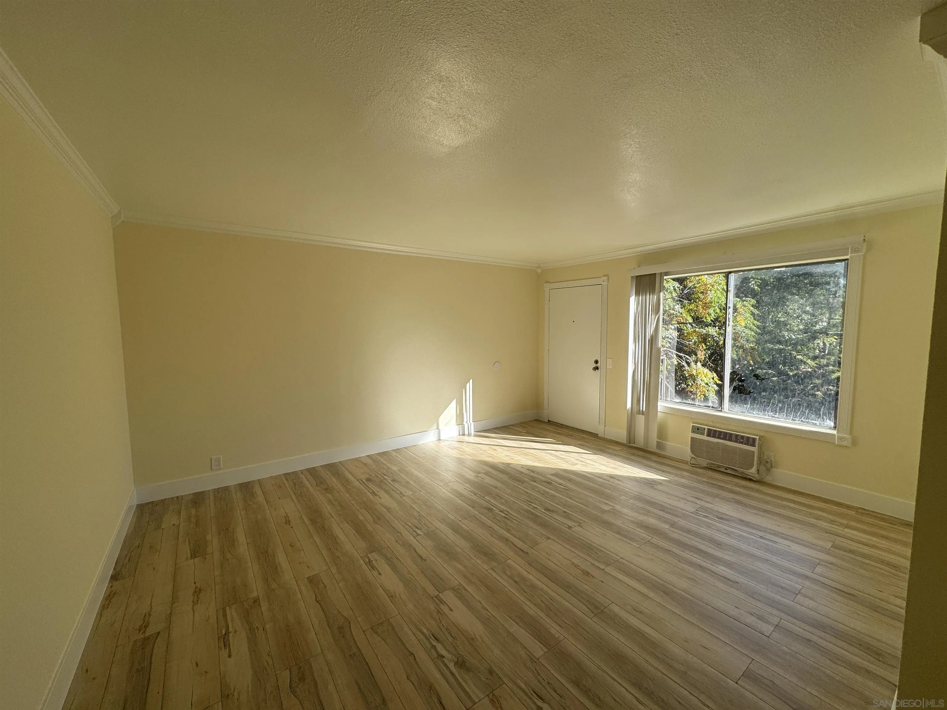 12923 Mapleview Street, Unit 8 Lakeside, CA 92040 - Photo 2 of 25 a view of an empty room with wooden floor and a window