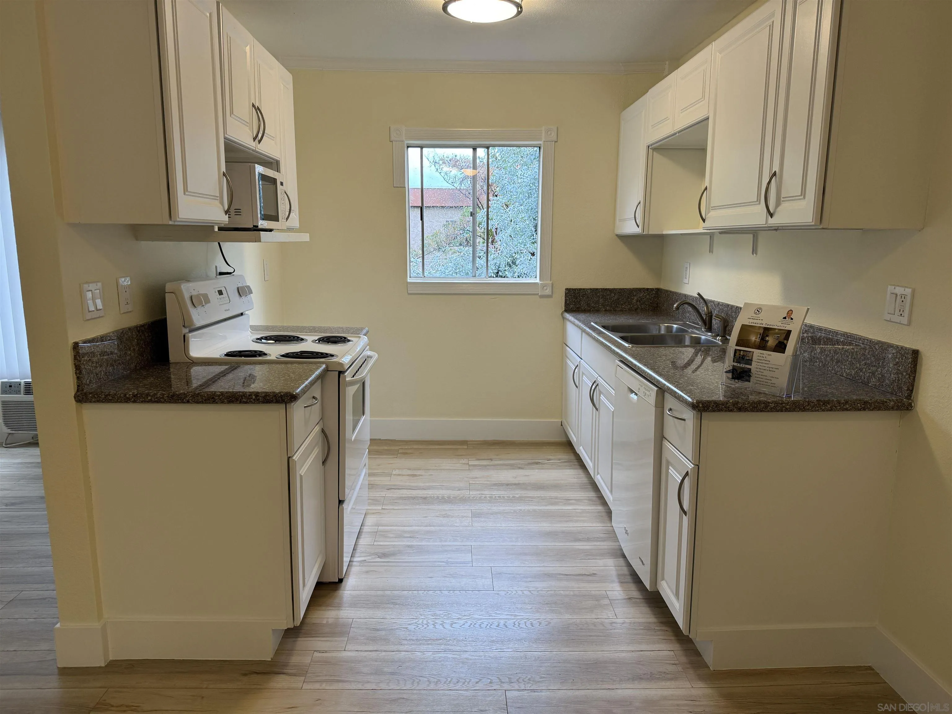 12923 Mapleview Street, Unit 8 Lakeside, CA 92040 - Photo 6 of 25 a kitchen with stainless steel appliances granite countertop a stove a sink and a refrigerator