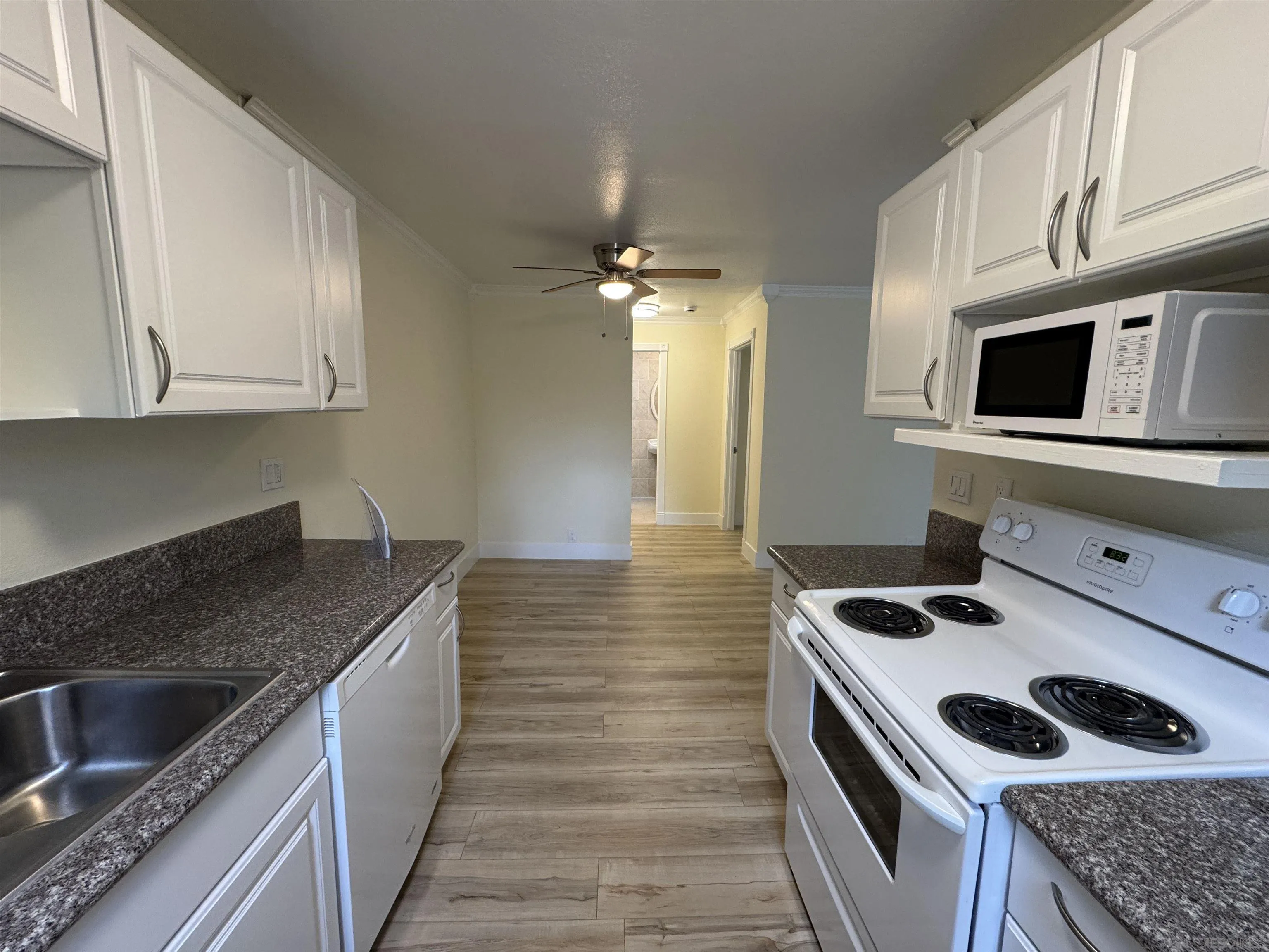 12923 Mapleview Street, Unit 8 Lakeside, CA 92040 - Photo 8 of 25 a kitchen with granite countertop a sink stove and cabinets