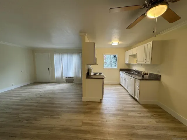 a view of kitchen with microwave and cabinets