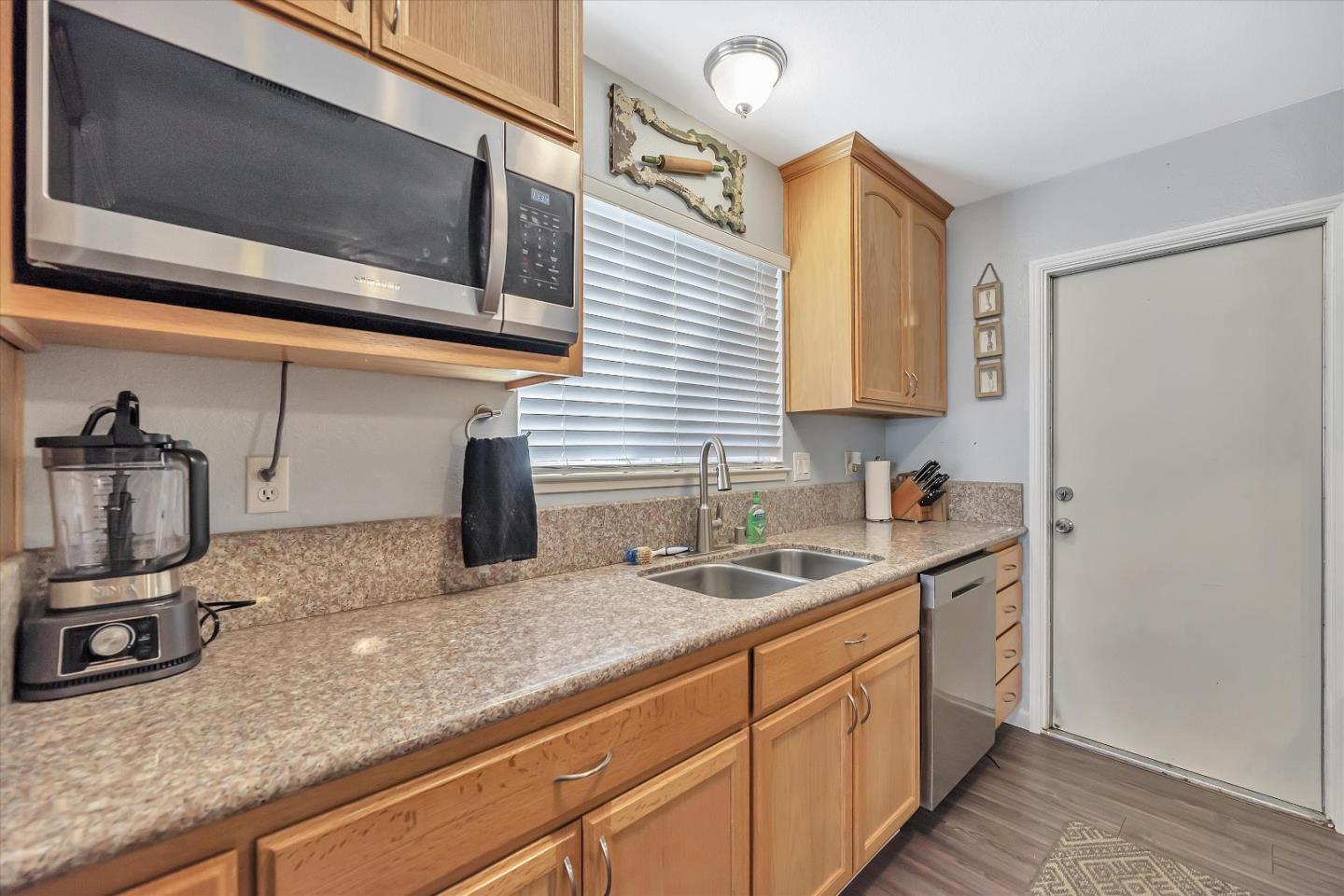 1391 3rd Street Gilroy, CA 95020 - Photo 17 of 40 a kitchen with stainless steel appliances granite countertop a sink and a microwave