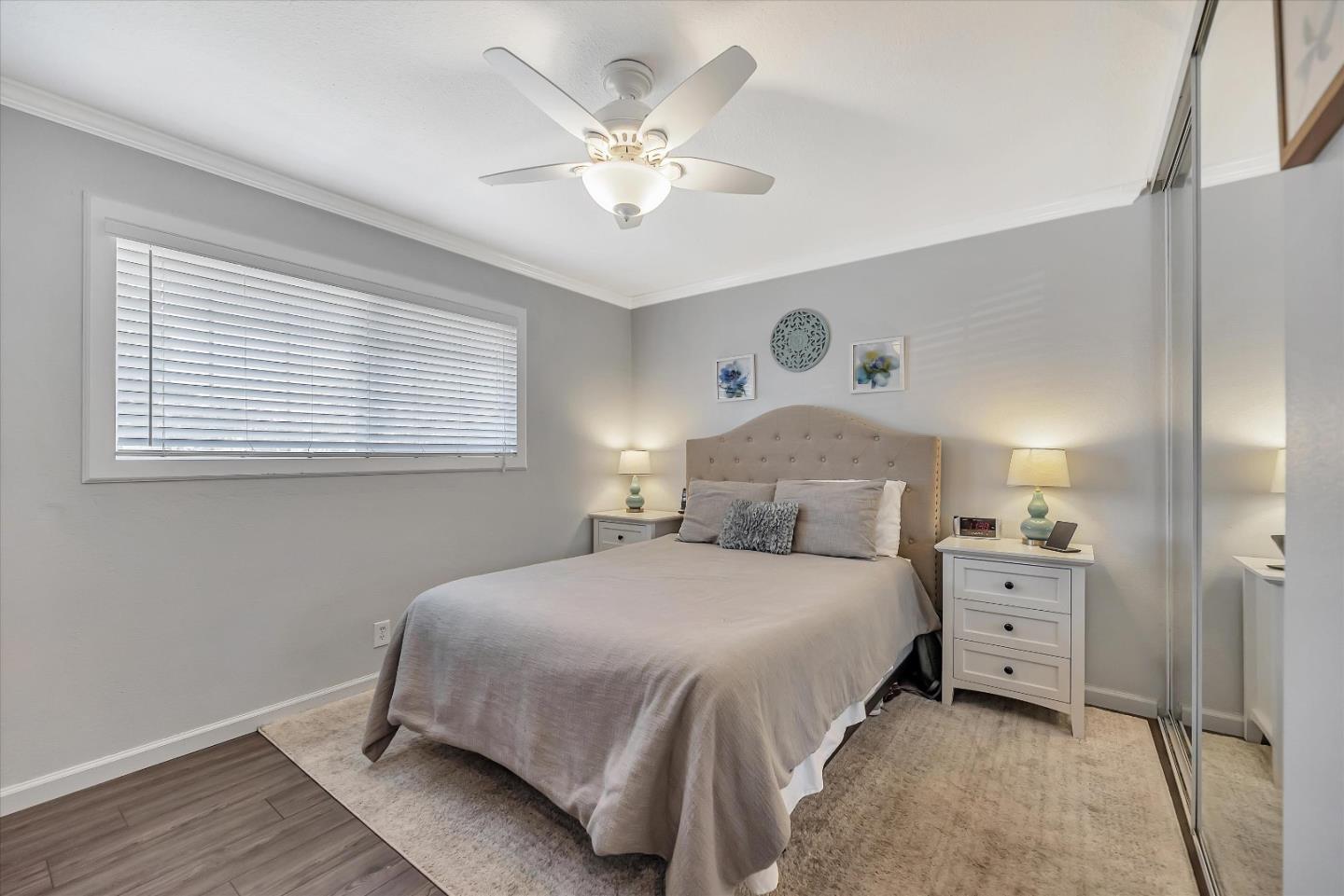 1391 3rd Street Gilroy, CA 95020 - Photo 25 of 40 a bedroom with a large bed and a chandelier