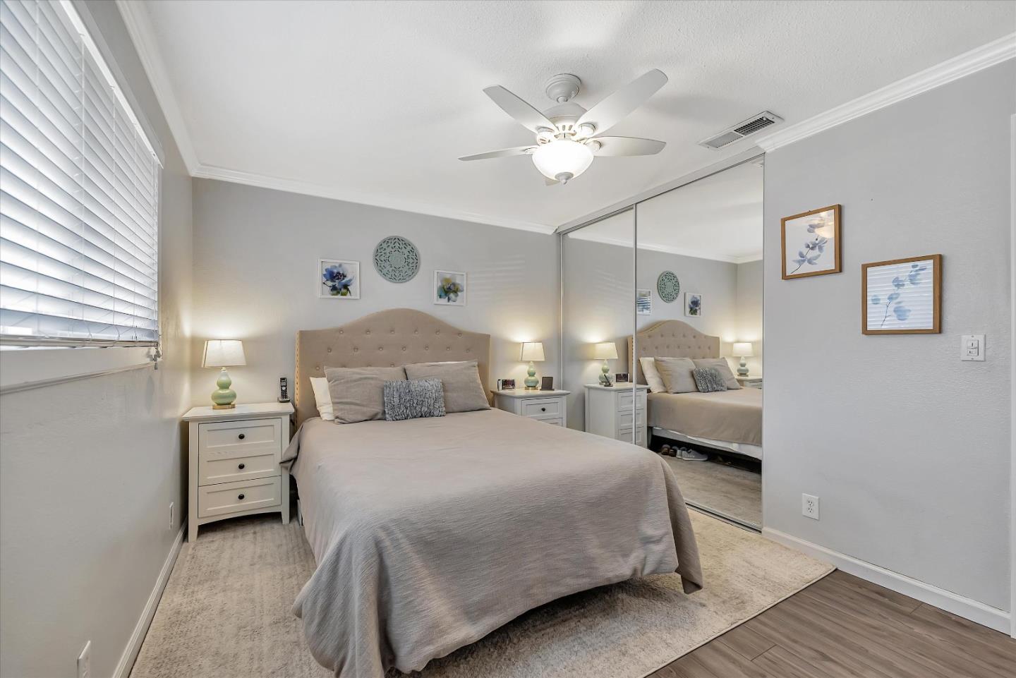 1391 3rd Street Gilroy, CA 95020 - Photo 26 of 40 a bedroom with a bed and a chandelier