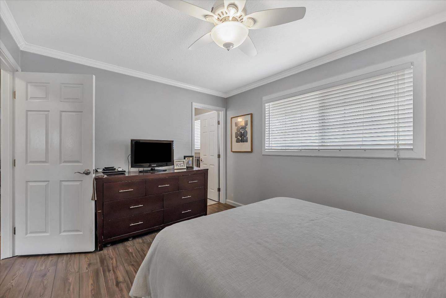 1391 3rd Street Gilroy, CA 95020 - Photo 27 of 40 a bedroom with a bed and a flat tv screen on dresser