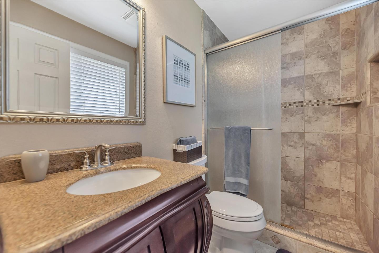1391 3rd Street Gilroy, CA 95020 - Photo 28 of 40 a bathroom with a granite countertop sink toilet and shower