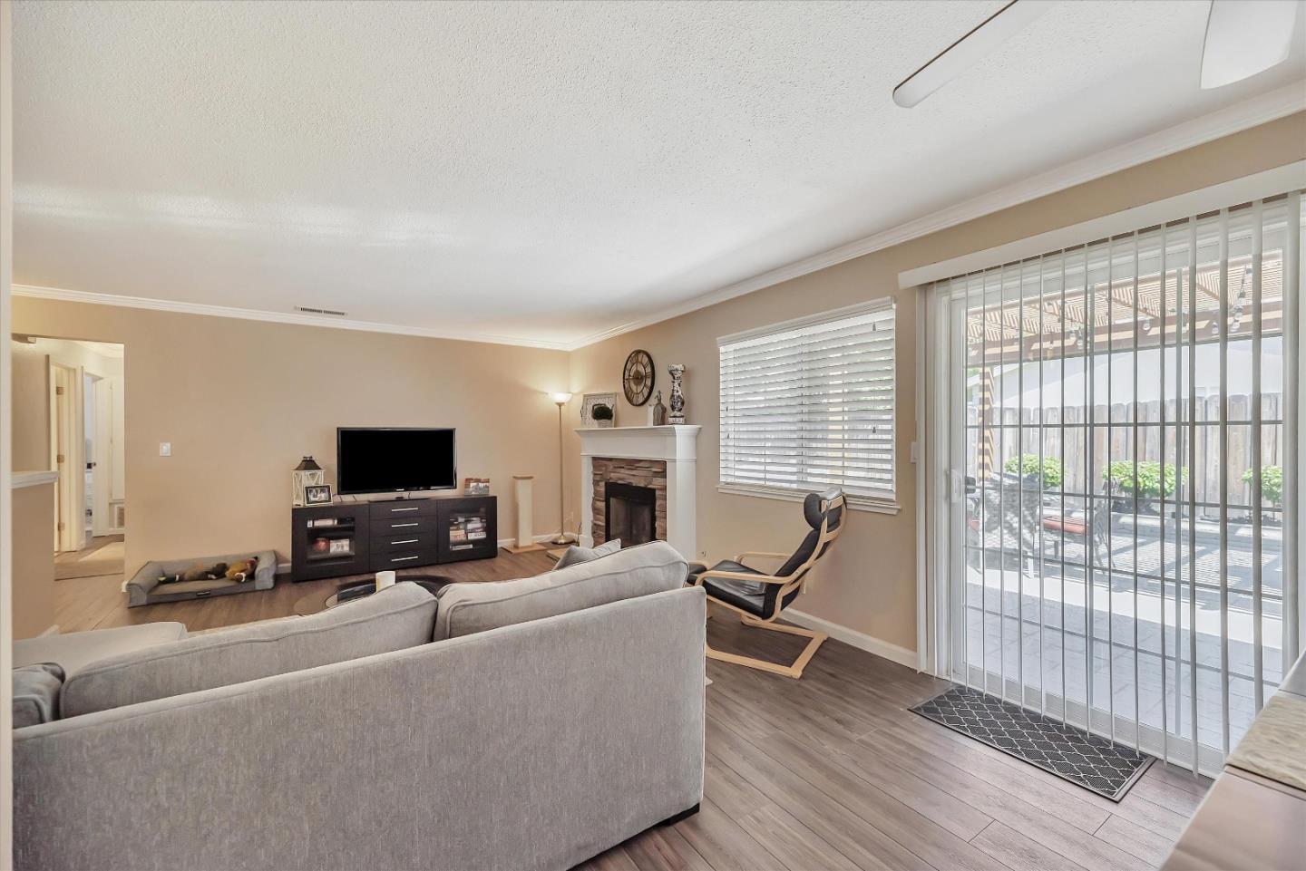 1391 3rd Street Gilroy, CA 95020 - Photo 7 of 40 a living room with furniture a fireplace and a flat screen tv