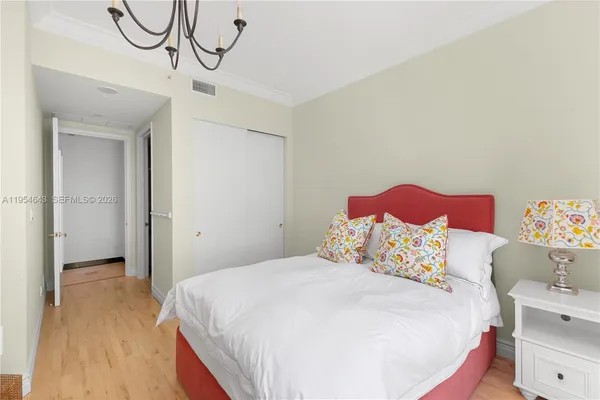 a bed room with a bed and a chair