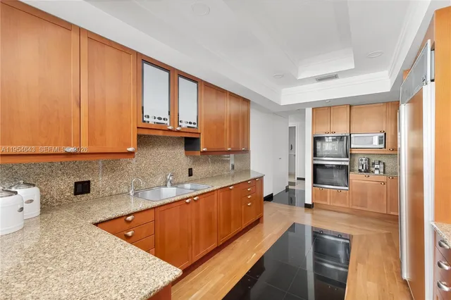a view of a dining room with furniture a chandelier and wooden floor