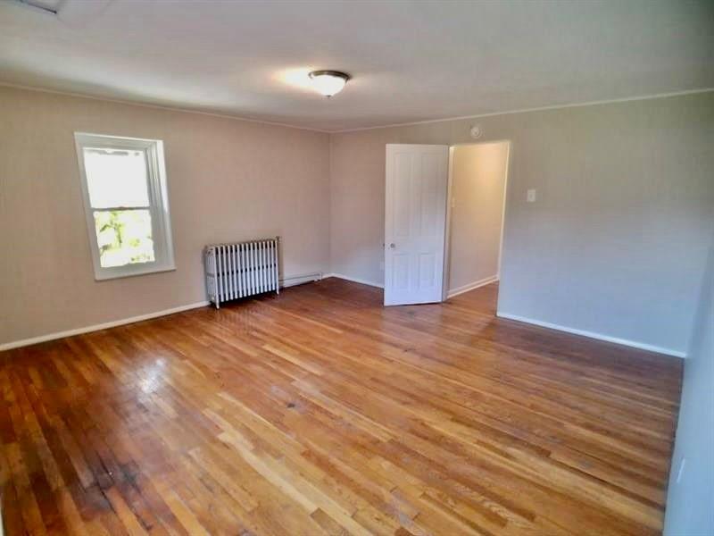 2118 Monroeville Road Monroeville, PA 15146 - Photo 8 of 11 an empty room with wooden floor and windows