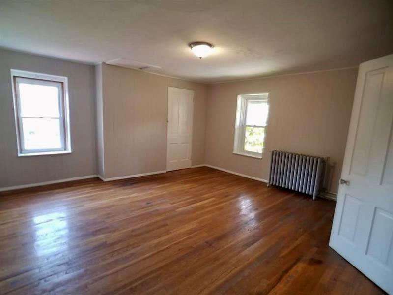 2118 Monroeville Road Monroeville, PA 15146 - Photo 10 of 11 an empty room with wooden floor and windows