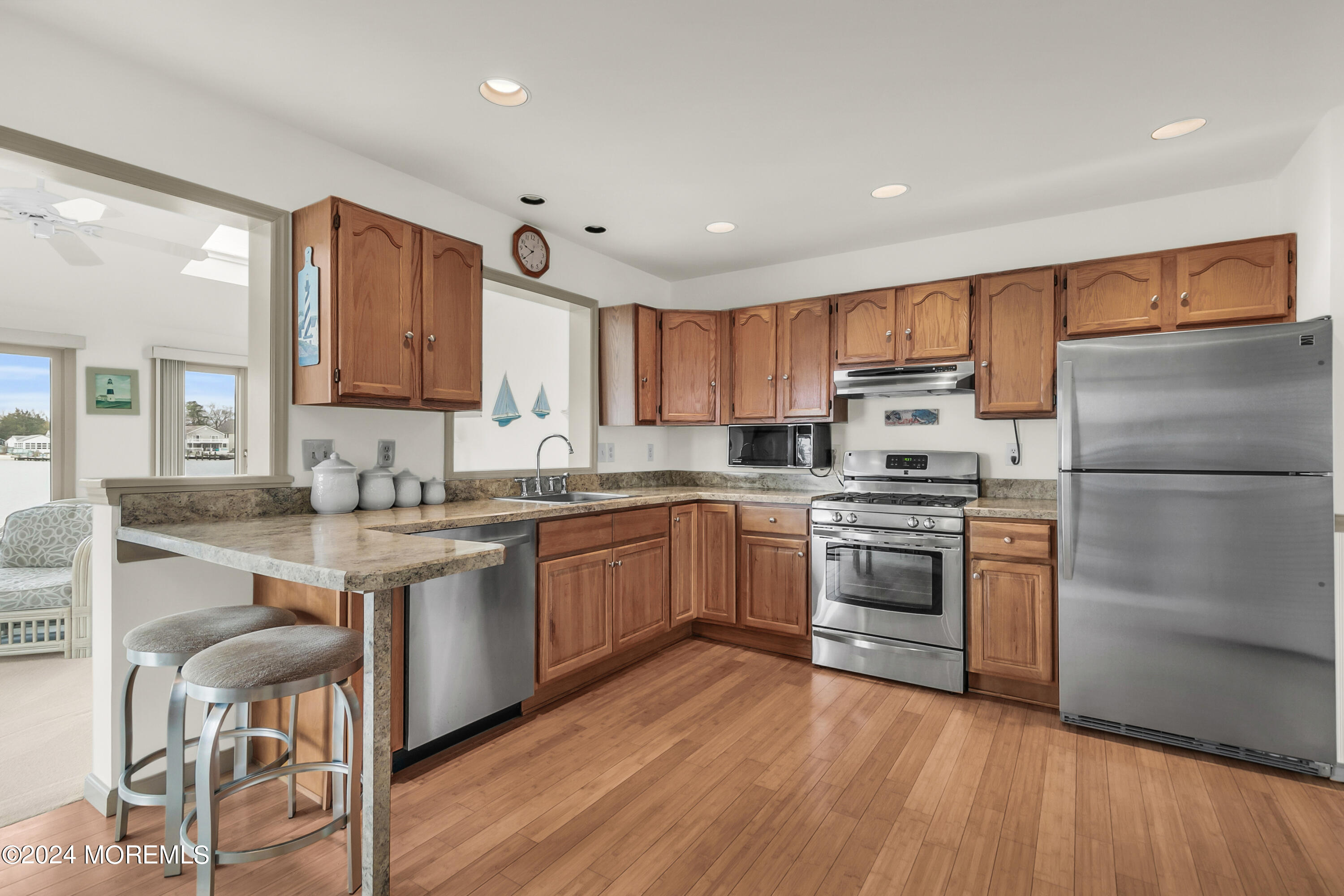 35 Bay Way Brick, NJ 08723 - Photo 12 of 48 a kitchen with a refrigerator stove a sink and a microwave