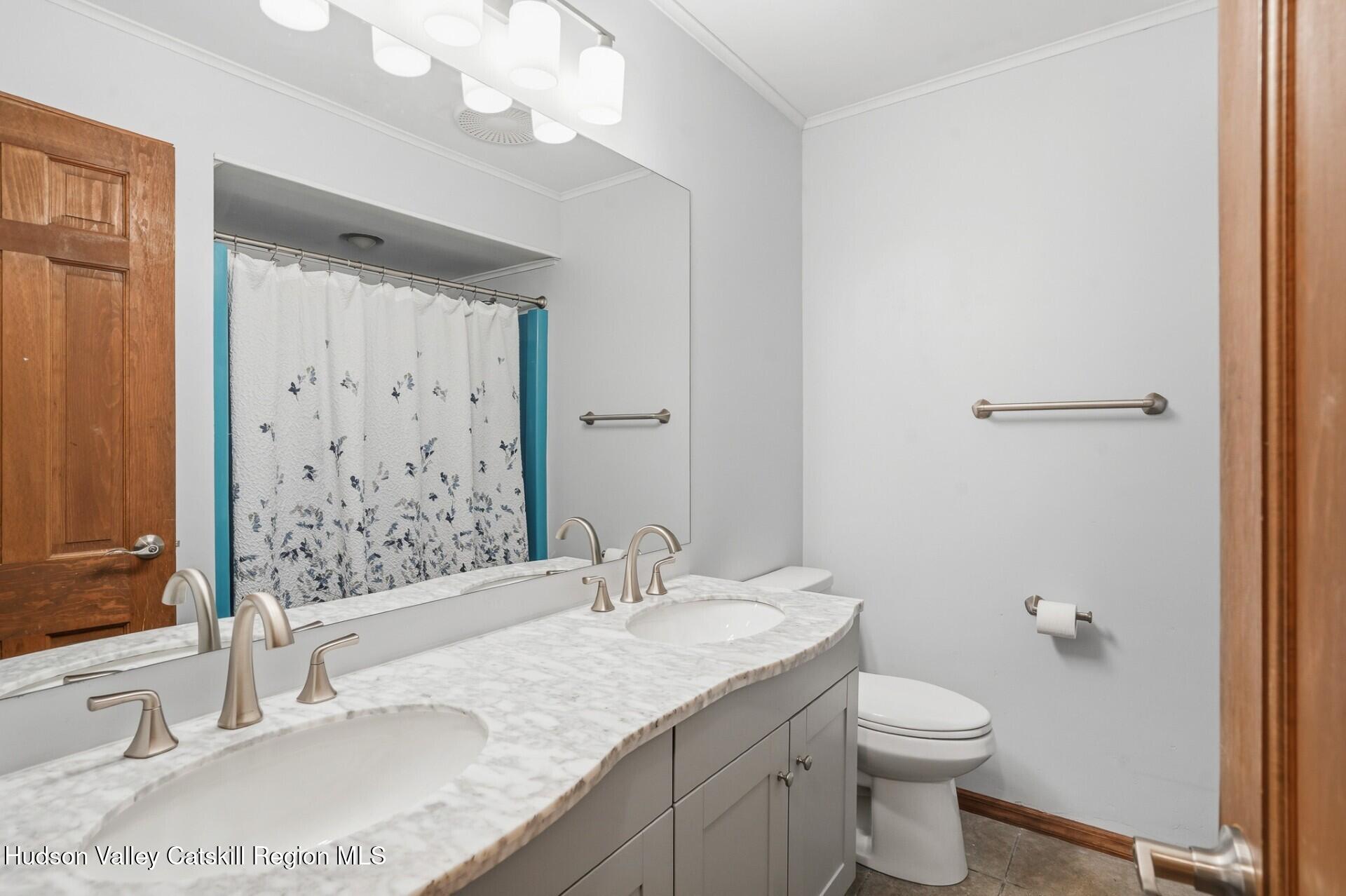 984 Blue Mountain Road Saugerties, NY 12477 - Photo 19 of 24 a bathroom with a granite countertop sink a toilet and shower