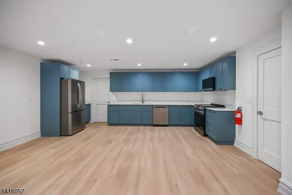 a large kitchen with stainless steel appliances kitchen island a sink dishwasher a refrigerator and a stove