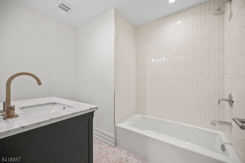 1209 Littleton Road, Unit A Morris Plains, NJ 07950 - Photo 18 of 23 a bathroom with a sink and a bathtub