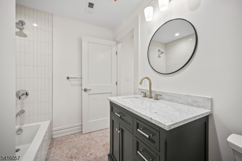 1209 Littleton Road, Unit A Morris Plains, NJ 07950 - Photo 20 of 23 a bathroom with a sink and a mirror