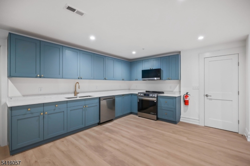 1209 Littleton Road, Unit A Morris Plains, NJ 07950 - Photo 5 of 23 a kitchen with stainless steel appliances granite countertop a sink dishwasher stove top oven and cabinets