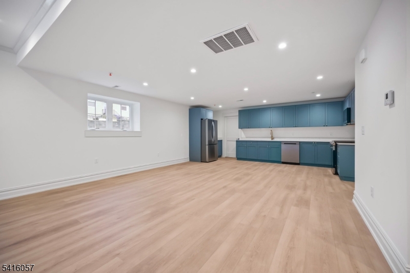1209 Littleton Road, Unit A Morris Plains, NJ 07950 - Photo 6 of 23 a view of empty room with wooden floor and windows