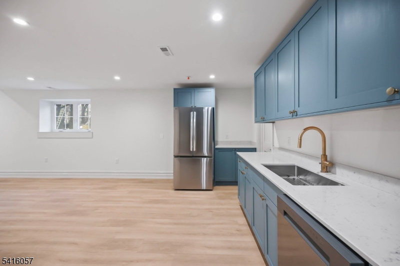 1209 Littleton Road, Unit A Morris Plains, NJ 07950 - Photo 8 of 23 a kitchen with stainless steel appliances granite countertop a sink a stove a refrigerator and cabinets
