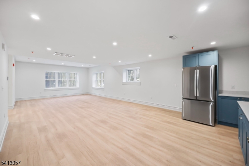 1209 Littleton Road, Unit A Morris Plains, NJ 07950 - Photo 10 of 23 a view of an empty room with wooden floor and a window