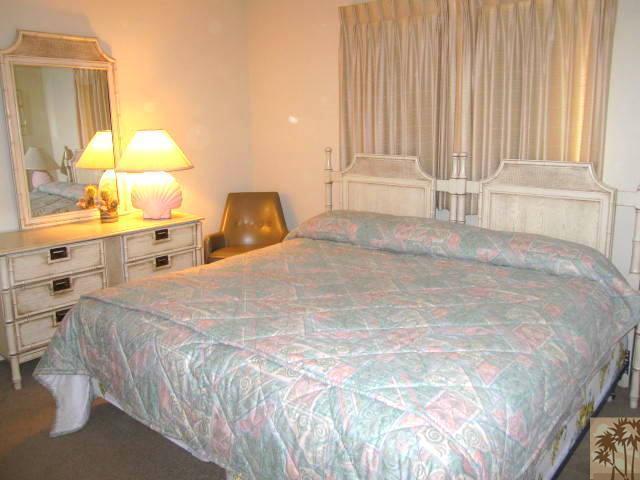 1268 Ramon Road, Unit 52 Palm Springs, CA 92264 - Photo 12 of 22 a large bed with a large mirror next to a window
