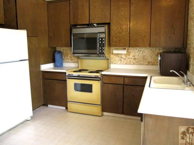 1268 Ramon Road, Unit 52 Palm Springs, CA 92264 - Photo 3 of 22 a kitchen with a sink stove and microwave