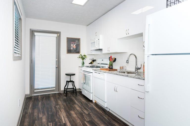 a kitchen with sink cabinets and wooden floor