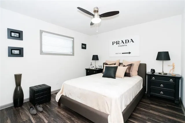 a bedroom with a bed and a chair