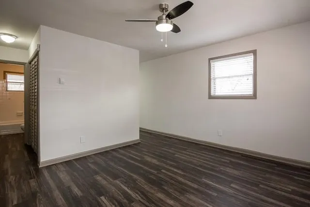wooden floor in an empty room with a window