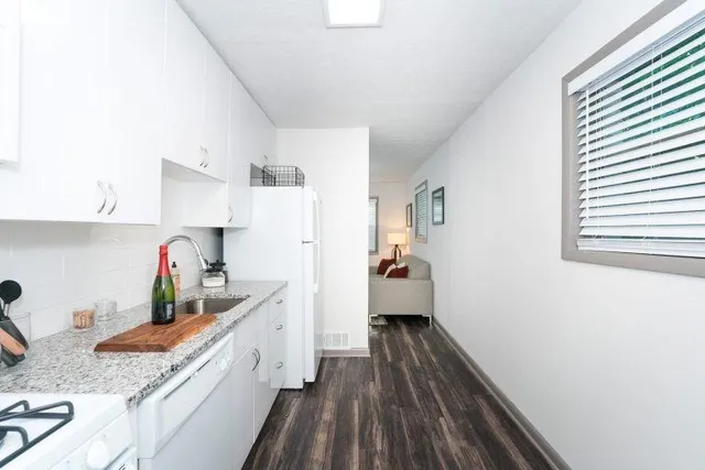 a kitchen with sink and cabinets