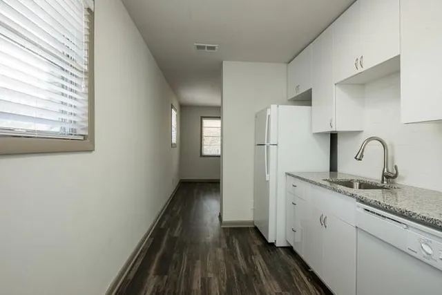 a view of a kitchen with a sink and dishwasher