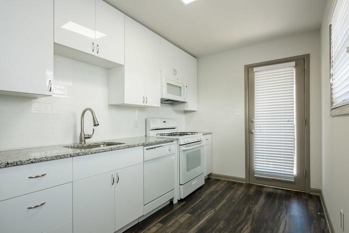 921 Myrtle Street Northeast, Unit MYRT006 Atlanta, GA 30309 - Photo 7 of 21 a kitchen with stainless steel appliances granite countertop a sink stove and cabinets