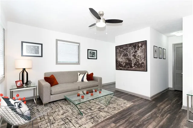 a living room with furniture and wooden floor