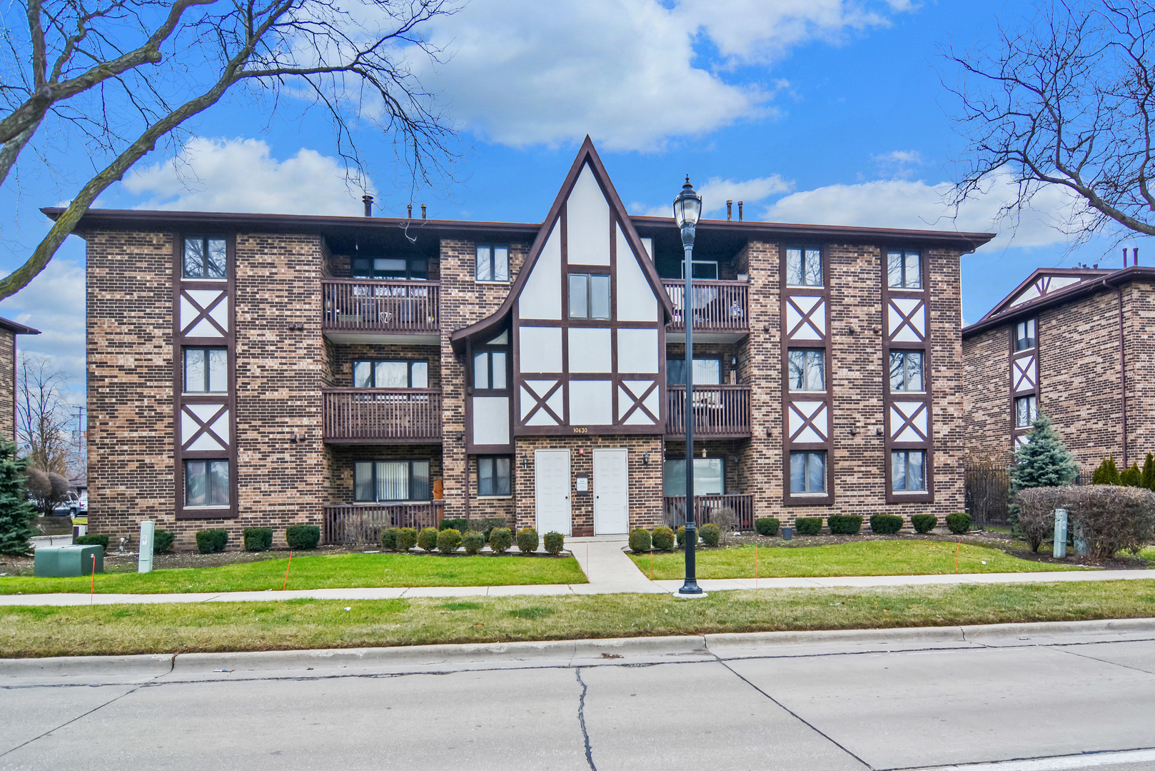 10630 Ridgeland Avenue, Unit 2A Chicago Ridge, IL 60415 - Photo 1 of 19 a front view of a house with a yard