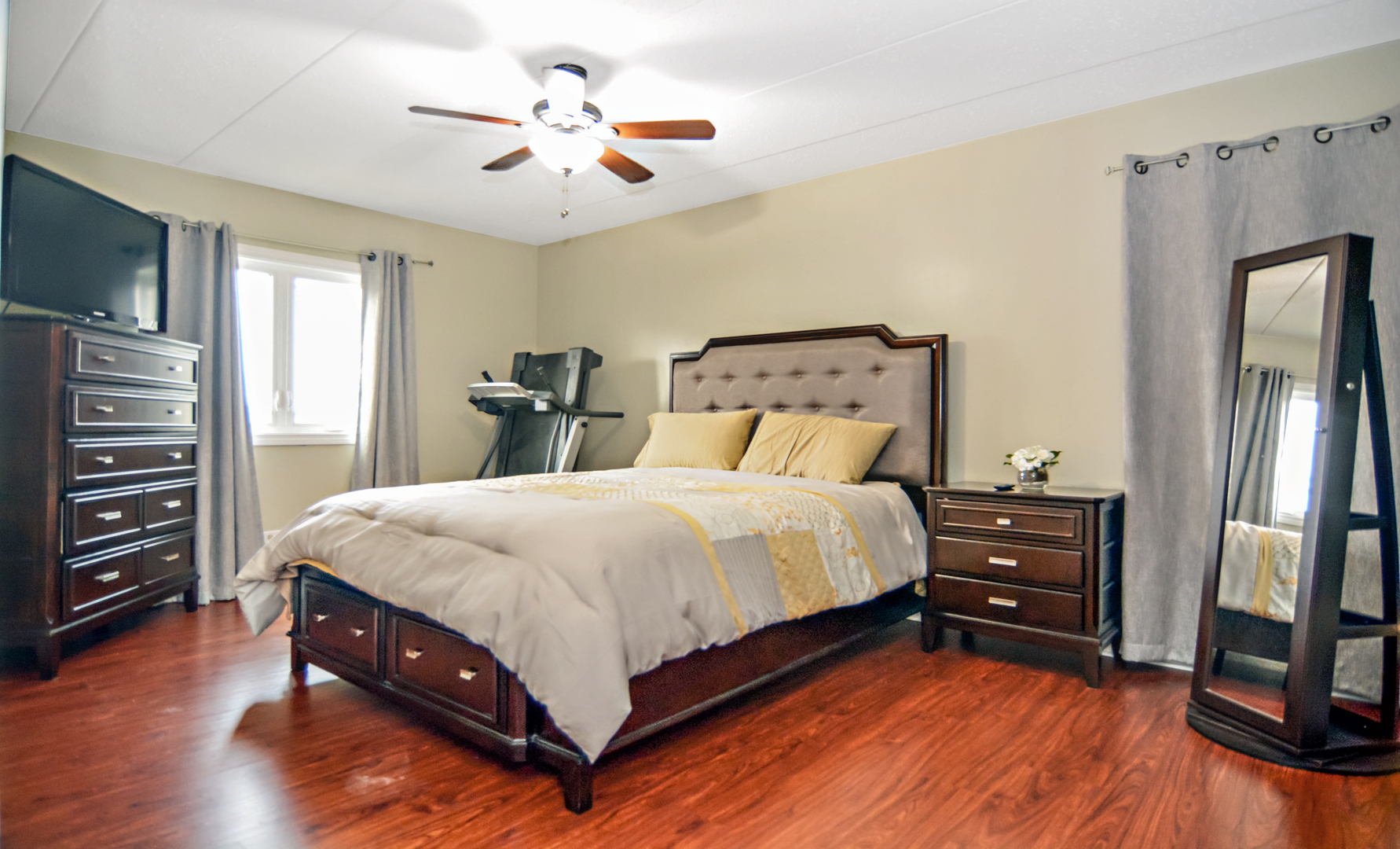 10630 Ridgeland Avenue, Unit 2A Chicago Ridge, IL 60415 - Photo 11 of 19 a bedroom with a bed and a tv on the dresser