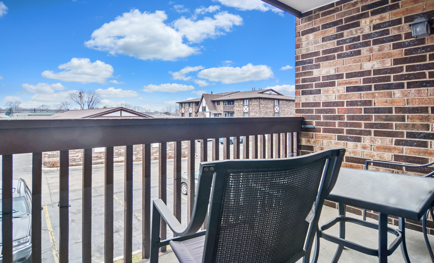 10630 Ridgeland Avenue, Unit 2A Chicago Ridge, IL 60415 - Photo 18 of 19 a view of a balcony with wooden chairs