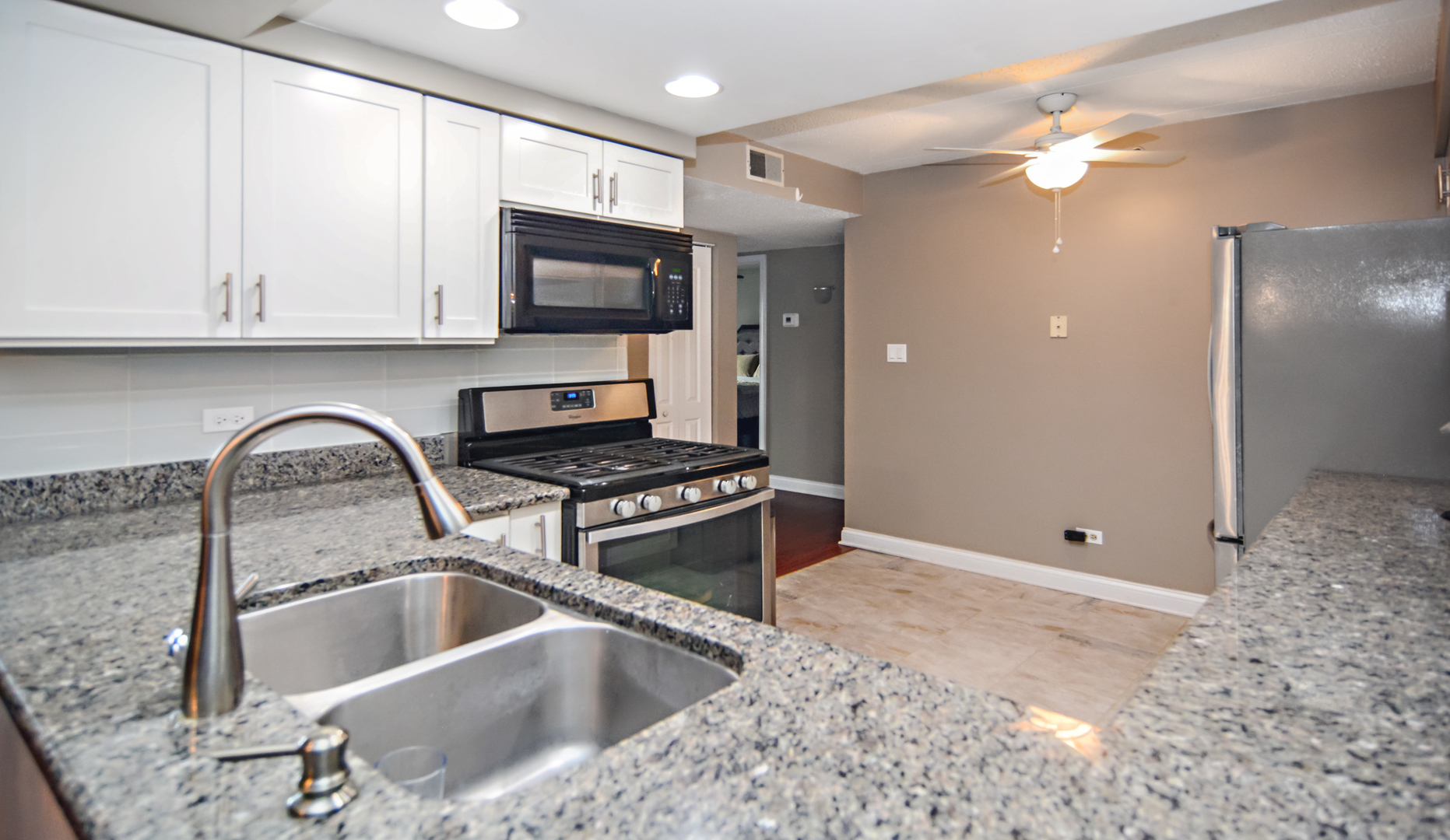 10630 Ridgeland Avenue, Unit 2A Chicago Ridge, IL 60415 - Photo 9 of 19 a kitchen with stainless steel appliances granite countertop a sink a stove and a refrigerator