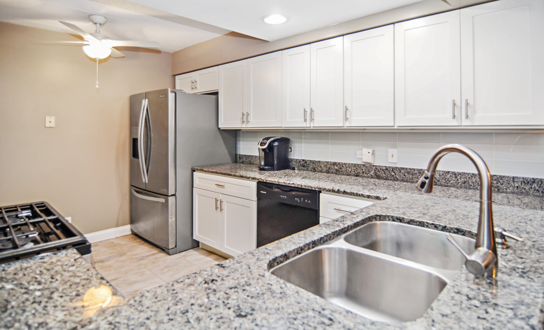 10630 Ridgeland Avenue, Unit 2A Chicago Ridge, IL 60415 - Photo 10 of 19 a kitchen with a sink cabinets and stainless steel appliances