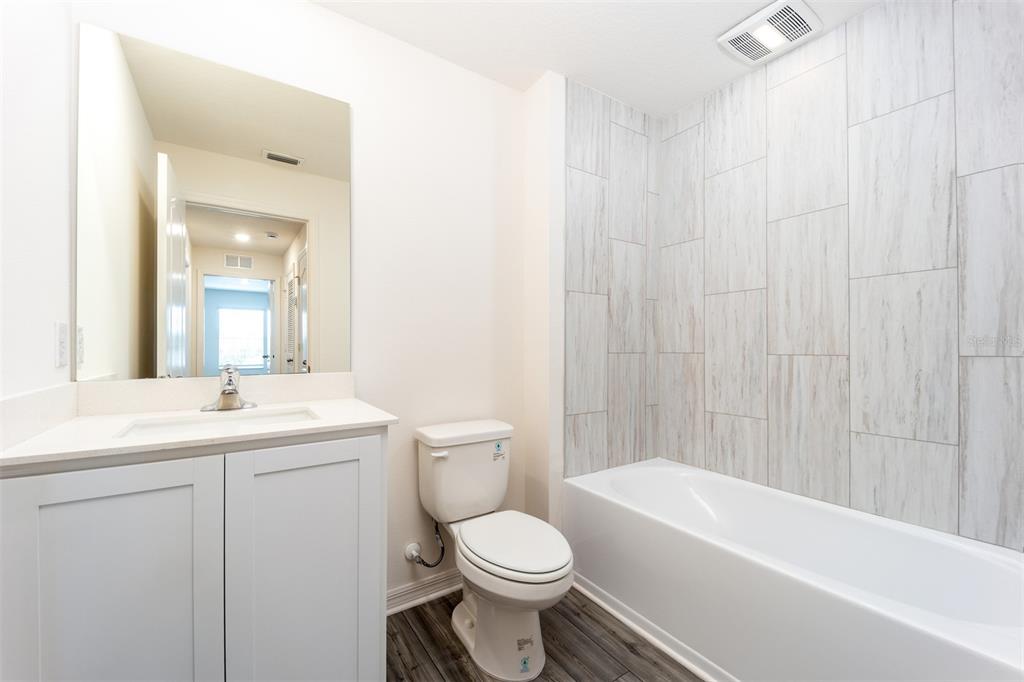 690 Poppy Lane Dundee, FL 33838 - Photo 15 of 16 a bathroom with a sink a toilet and a bathtub