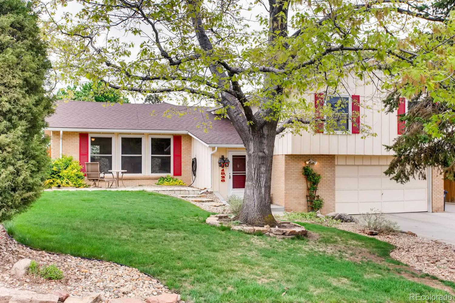 1926 Foothills Road Golden, CO 80401 - Photo 1 of 28 a front view of a house with a garden and yard