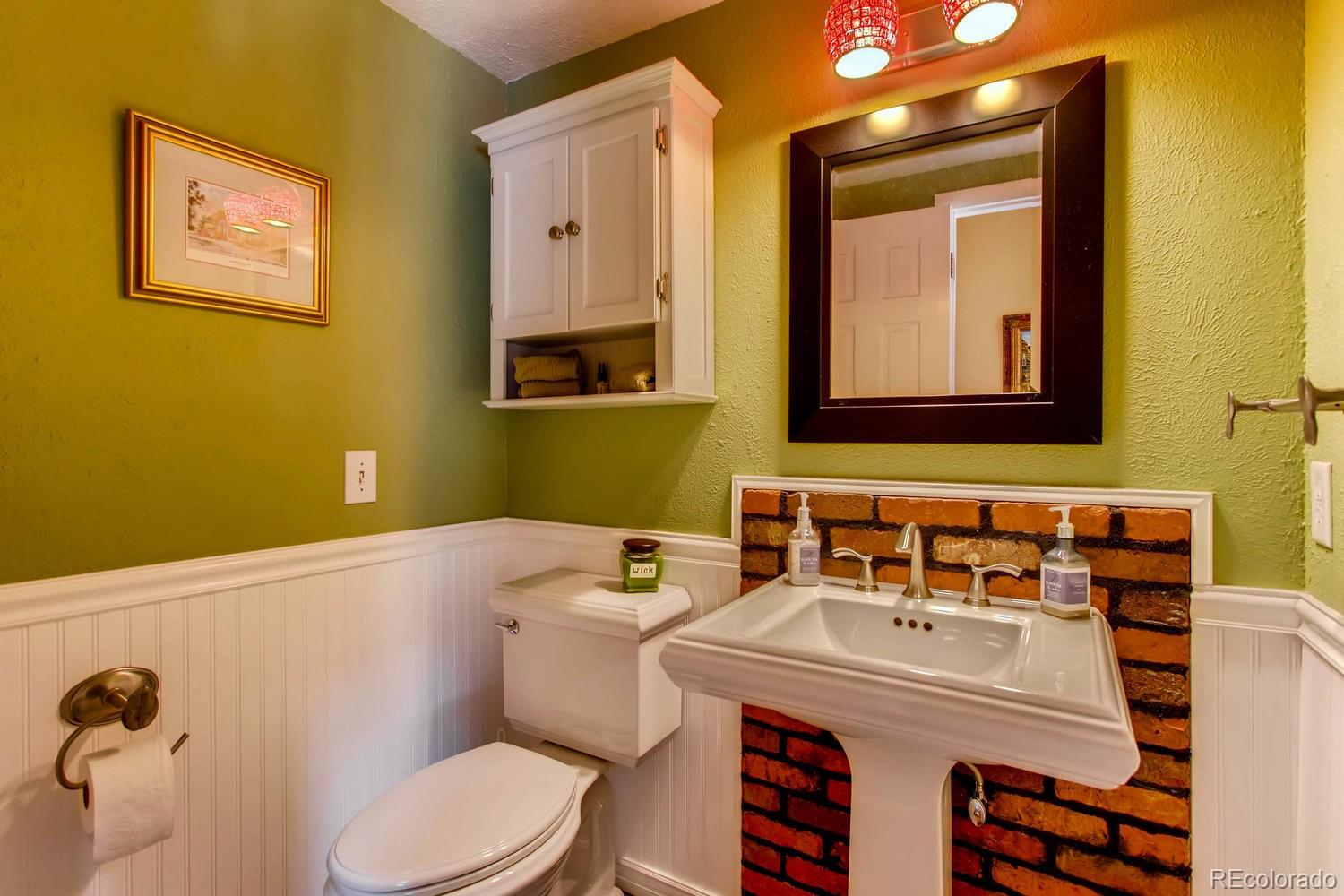 1926 Foothills Road Golden, CO 80401 - Photo 14 of 28 a bathroom with a sink mirror and toilet