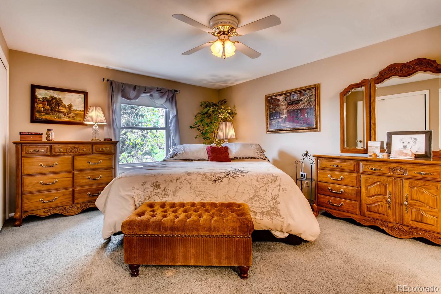 1926 Foothills Road Golden, CO 80401 - Photo 15 of 28 a bedroom with a bed a dresser and painting on the wall