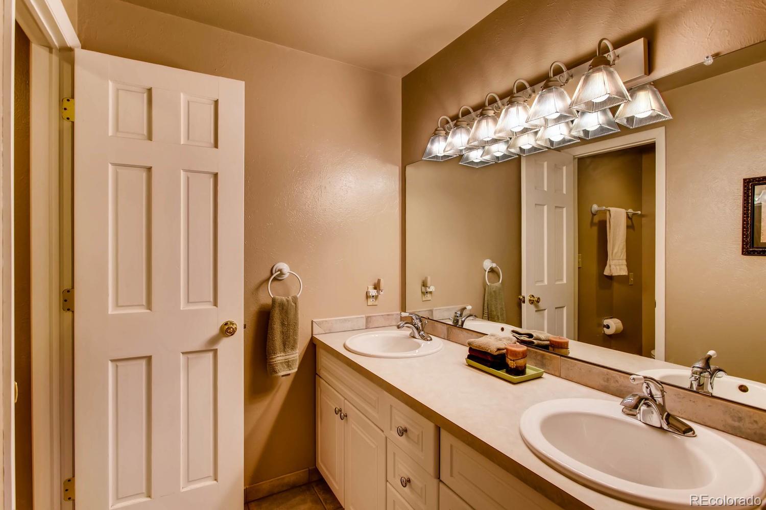 1926 Foothills Road Golden, CO 80401 - Photo 17 of 28 a bathroom with a double vanity sink and a mirror