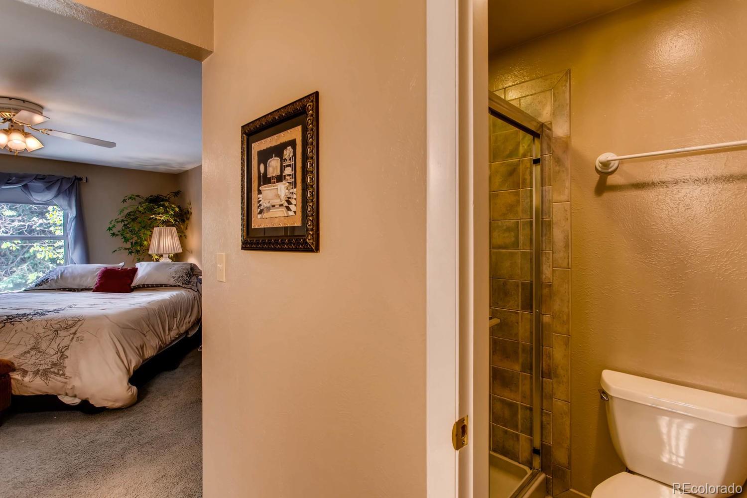 1926 Foothills Road Golden, CO 80401 - Photo 18 of 28 a bedroom with a bed and a mirror