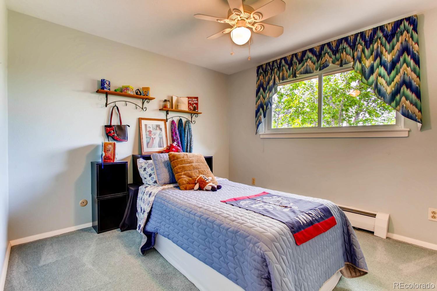 1926 Foothills Road Golden, CO 80401 - Photo 19 of 28 a bed room with a bed and a chandelier