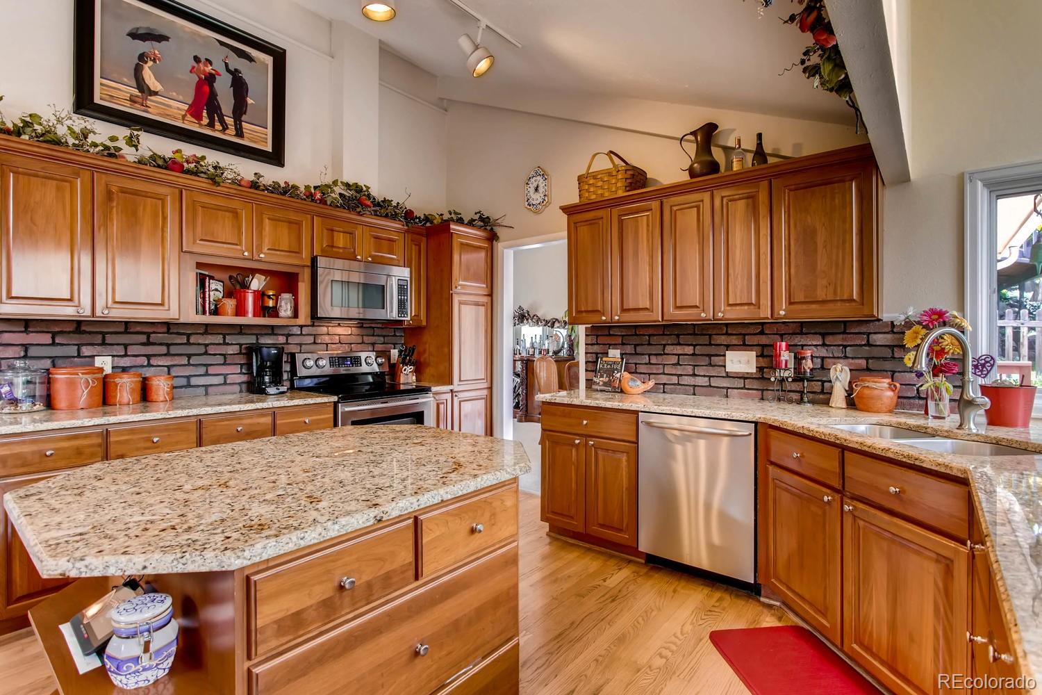 1926 Foothills Road Golden, CO 80401 - Photo 9 of 28 a kitchen with stainless steel appliances granite countertop a stove a sink and a microwave