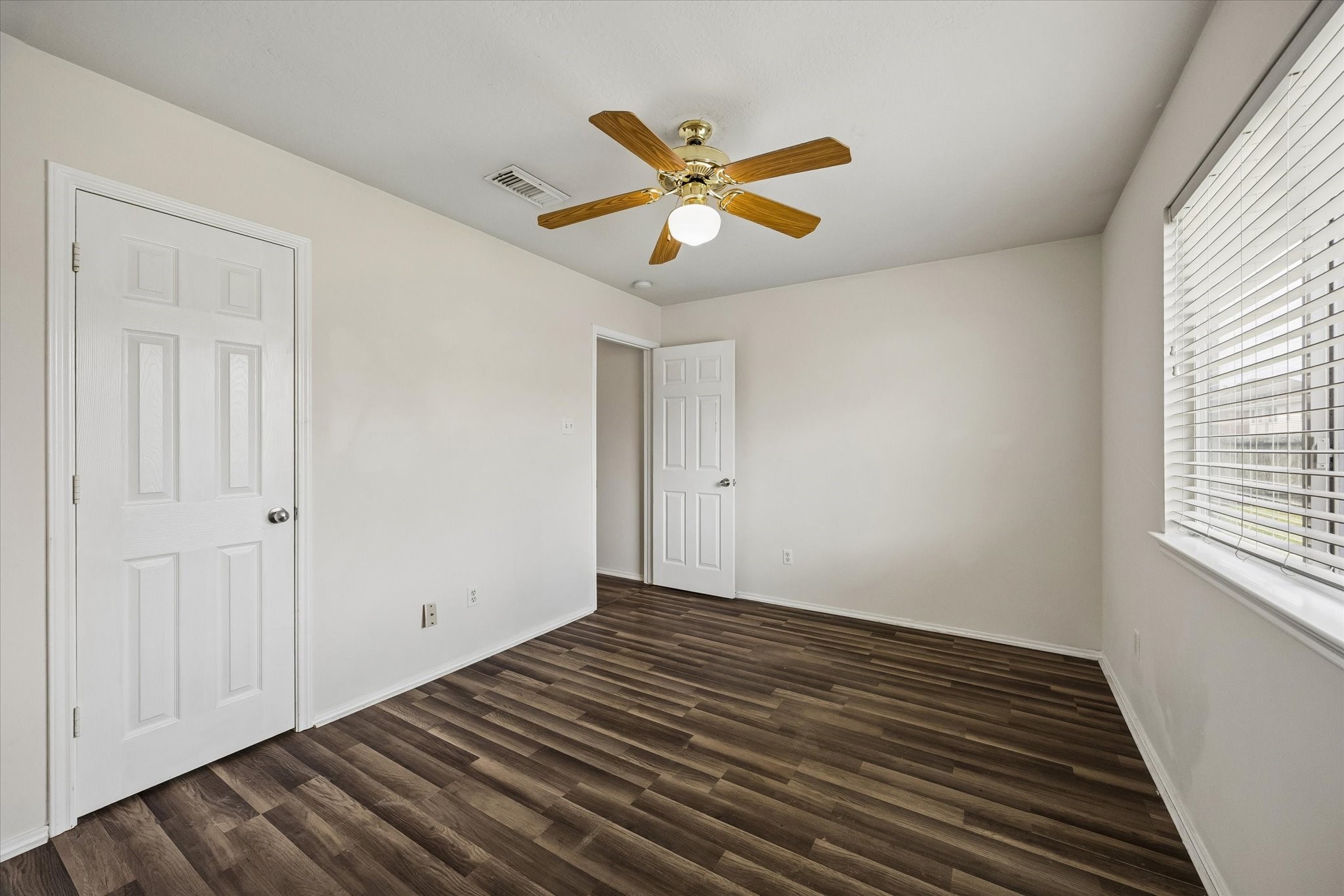 2614 Balsam Ridge Way Fresno, TX 77545 - Photo 12 of 14 a view of an empty room with wooden floor and a window