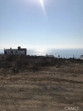 a view of an ocean beach and mountain