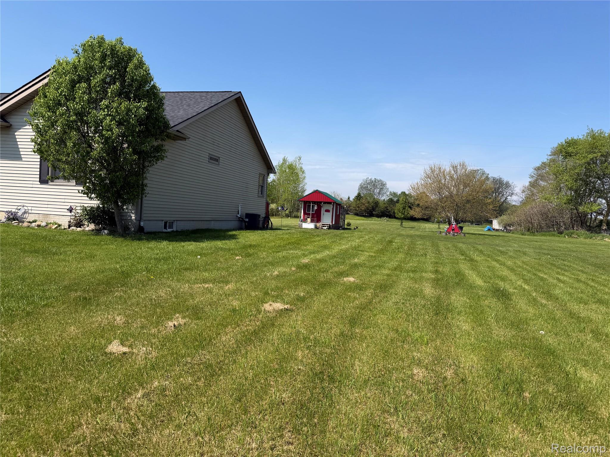 6860 Grand River Road Bancroft, MI 48414 - Photo 27 of 31 View of green lawn with an outbuilding